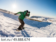 Snowboard freerider in the mountains against sun shine in blue sky. Стоковое фото, агентство Ingram Publishing / Фотобанк Лори