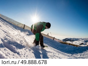 Snowboard freerider in the mountains against sun shine in blue sky. Стоковое фото, агентство Ingram Publishing / Фотобанк Лори