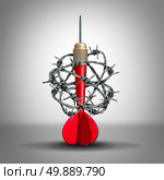 Goal challenge and opportunity problem as a business concept with a red dart wrapped with sharp metal barbed wire as a metaphor for unfair accessibility and adversity in reaching goals. Стоковое фото, агентство Ingram Publishing / Фотобанк Лори
