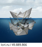 Living off others concept and corner the market symbol as a dominant paper boat dominating a group of smaller boats tied together helping the leader float above water as a metaphor for leadership. Стоковое фото, агентство Ingram Publishing / Фотобанк Лори