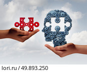 Concept of business training and skill development symbol as human hands holding a puzzle piece and gears shaped as a head as a technology or training metaphor with 3D illustration elements. Стоковое фото, агентство Ingram Publishing / Фотобанк Лори