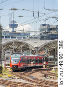 red train depart from the station Cologne Germany. Стоковое фото, агентство Ingram Publishing / Фотобанк Лори