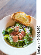 Caesar Salad with parma ham on wooden table. Стоковое фото, агентство Ingram Publishing / Фотобанк Лори