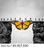 Opportunity and transition concept or migration as a butterfly acting as a bridge between two cliffs for people to go to their journey as a symbol for hope and faith with 3D illustration elements. Стоковое фото, агентство Ingram Publishing / Фотобанк Лори