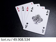 ace four of a kind poker card on dark black background. Стоковое фото, агентство Ingram Publishing / Фотобанк Лори