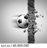 Soccer power and european football strength as a sport equipment ball breaking through and crushing a cement wall as a victory and strongest champion metaphor with 3D illustration elements. Стоковое фото, агентство Ingram Publishing / Фотобанк Лори