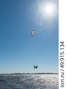 Kiteboarder enjoy surfing on a sunny day. Стоковое фото, агентство Ingram Publishing / Фотобанк Лори