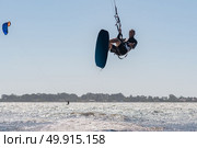 Kiteboarder enjoy surfing on a sunny day. Стоковое фото, агентство Ingram Publishing / Фотобанк Лори