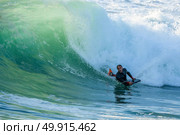 Bodyboarder in action on the ocean waves on a sunny day. Стоковое фото, агентство Ingram Publishing / Фотобанк Лори