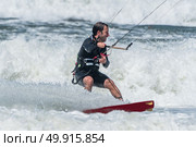 Kiteboarder enjoy surfing on a sunny day. Стоковое фото, агентство Ingram Publishing / Фотобанк Лори