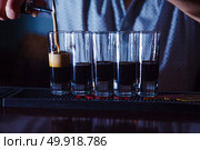 Preparation of shots cocktails. B-52 close-up. Стоковое фото, агентство Ingram Publishing / Фотобанк Лори
