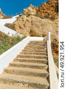 Stairs to a pool of natural sea water between sandstone cliffs at Algar Seco. Carvoeiro Algarve Portugal. Стоковое фото, агентство Ingram Publishing / Фотобанк Лори