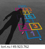 Child predator and threatening stranger shadow on a kid or child playground with a hopscotch game as a criminal child abuse concept in a 3D illustration style. Стоковое фото, агентство Ingram Publishing / Фотобанк Лори