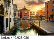 Venetian cityscape with water canal and small bridge at sunrise, Italy. Стоковое фото, агентство Ingram Publishing / Фотобанк Лори