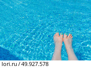 Relaxation by the Poolside With Feet Dipped in Refreshing Blue Water. Стоковое фото, фотограф Мара Фрибус / Фотобанк Лори