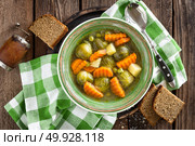 Vegetable soup with brussel sprouts on wooden rustic table, top view. Стоковое фото, агентство Ingram Publishing / Фотобанк Лори