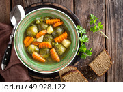 Vegetable soup with brussel sprouts on wooden rustic table, top view. Стоковое фото, агентство Ingram Publishing / Фотобанк Лори