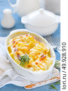 Baked potato gratin with garlic, cream and cheese, traditional french cuisine. White background. Стоковое фото, агентство Ingram Publishing / Фотобанк Лори
