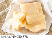 Parmesan cheese on white wooden background. Стоковое фото, агентство Ingram Publishing / Фотобанк Лори