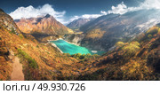 Scenic view on high Himalayan mountains, amazing mountain lake with turquoise water, hills, yellow grass, trees and blue sky with clouds at sunset in Nepal. Panoramic landscape with mountain valley . Стоковое фото, агентство Ingram Publishing / Фотобанк Лори