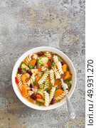 Minestrone soup. Vegetable soup with fresh tomato, celery, carrot, zucchini, onion, pepper, beans and pasta. Dish of italian cuisine. Стоковое фото, агентство Ingram Publishing / Фотобанк Лори