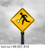 Guns and children and firearms or weapons access and violence on a child as a kid crossing traffic sign with a gunshot hole as a safety and risk symbol as a 3D illustration. Стоковое фото, агентство Ingram Publishing / Фотобанк Лори