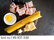 Ingredients for cooking Carbonara pasta, spaghetti with pancetta, egg and hard parmesan cheese. Traditional italian cuisine. Pasta alla carbonara. Стоковое фото, агентство Ingram Publishing / Фотобанк Лори
