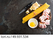 Ingredients for cooking Carbonara pasta, spaghetti with pancetta, egg and hard parmesan cheese. Traditional italian cuisine. Pasta alla carbonara. Стоковое фото, агентство Ingram Publishing / Фотобанк Лори