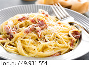 Carbonara pasta, spaghetti with pancetta, egg, hard parmesan cheese and cream sauce. Traditional italian cuisine. Pasta alla carbonara. Стоковое фото, агентство Ingram Publishing / Фотобанк Лори