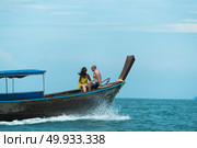Phuket, THAILAND - March  4, 2017. A tourist wearing a bikini swim in the sea in Phuket. Редакционное фото, агентство Ingram Publishing / Фотобанк Лори