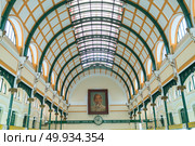 Saigon, Vietnam - January 26 2016: Interior of the historical central Post Office in Saigon with a large portrait of Ho Chi Minh. Редакционное фото, агентство Ingram Publishing / Фотобанк Лори