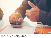 Business hand putting stamp on a document, close up. Стоковое фото, агентство Ingram Publishing / Фотобанк Лори