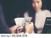 Close-up Of Person Hand Giving Money To Other Hand. Стоковое фото, агентство Ingram Publishing / Фотобанк Лори