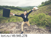Cheerful Business Man Jumping and Shouting, Successful Corporate People Yelling and Celebrating Joy of Success on Mountain Peak. Стоковое фото, агентство Ingram Publishing / Фотобанк Лори
