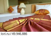 Messy luxurious bed with pillow and quilt cover. Стоковое фото, агентство Ingram Publishing / Фотобанк Лори