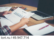 young  Businessman woman hands reviewing analyzing financial dat. young  Businessman woman hands reviewing analyzing financial data chart. . Стоковое фото, агентство Ingram Publishing / Фотобанк Лори