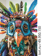 A person wearing a colorful handmade mask with feathers and beadwork, representing a bird, at a cultural event. Стоковое AI-изображение, AI-художник Данила Большаков / Фотобанк Лори