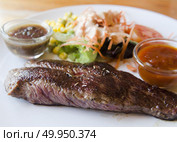 grilled ostrich steak with spicy turkey sauce, styled with onion and mushroom. Стоковое фото, агентство Ingram Publishing / Фотобанк Лори