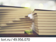 Book stack in the library room and blurred bookshelf for busines. Book stack in the library room and blurred bookshelf for business and education background, back to school concept. Book stack in the library room and blurred bookshelf for business and education background, back to school concept. Стоковое фото, агентство Ingram Publishing / Фотобанк Лори