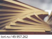 Book stack in the library room and blurred bookshelf for busines. Book stack in the library room and blurred bookshelf for business and education background, back to school concept. Book stack in the library room and blurred bookshelf for business and education background, back to school concept. Стоковое фото, агентство Ingram Publishing / Фотобанк Лори