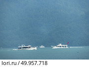 Nantou, Taiwan - November 02, 2016 : Tourist boats docking in peachful morning at Shuishe Pier, Sun Moon Lake, Taiwan. Редакционное фото, агентство Ingram Publishing / Фотобанк Лори