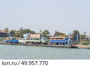 MAY, 2015 - Mae Sai, Thailand: Man fishing into the Mekong river on his long tail boat. Редакционное фото, агентство Ingram Publishing / Фотобанк Лори