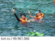 Phuket, THAILAND - JANUARY 4, 2017. A tourist wearing a bikini swim in the sea in Phuket. Редакционное фото, агентство Ingram Publishing / Фотобанк Лори