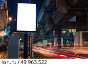 Blank billboard with copy space area for your text message or promotional content, public information board next to road in night.. Blank billboard with copy space area for your text message or pr. Стоковое фото, агентство Ingram Publishing / Фотобанк Лори
