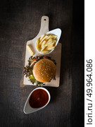 Top view of Rustic homemade hamburger and french fries with tomato sauce.. Top view of Rustic homemade hamburger and french fries with toma. Стоковое фото, агентство Ingram Publishing / Фотобанк Лори