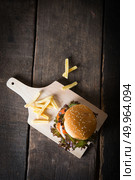 Top view of Rustic homemade hamburger and french fries with tomato sauce.. Top view of Rustic homemade hamburger and french fries with toma. Стоковое фото, агентство Ingram Publishing / Фотобанк Лори