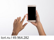 Close Up of a woman holding on mobile phone isolated on white ba. Close Up of a woman holding on mobile phone isolated on white background. Стоковое фото, агентство Ingram Publishing / Фотобанк Лори