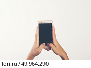 Close Up of a woman holding on mobile phone isolated on white ba. Close Up of a woman holding on mobile phone isolated on white background. Стоковое фото, агентство Ingram Publishing / Фотобанк Лори