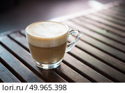Close up of cappuccino cup with heart shaped milk pattern at caf. Close up of cappuccino cup with heart shaped milk pattern at cafe. a cup of coffee art. Стоковое фото, агентство Ingram Publishing / Фотобанк Лори