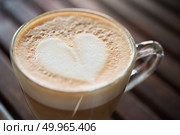 Close up of cappuccino cup with heart shaped milk pattern at caf. Close up of cappuccino cup with heart shaped milk pattern at cafe. a cup of coffee art. Стоковое фото, агентство Ingram Publishing / Фотобанк Лори